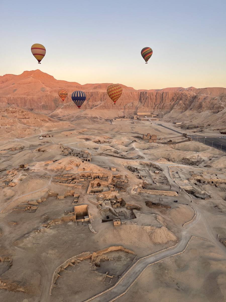 Hot air balloons over the Valley of the Kings at sunrise near Luxor, Egypt