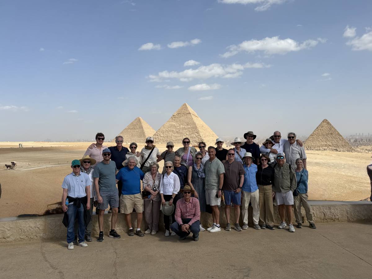 Luxury Egypt tour group with Cultured Travel posing at the Pyramids of Giza