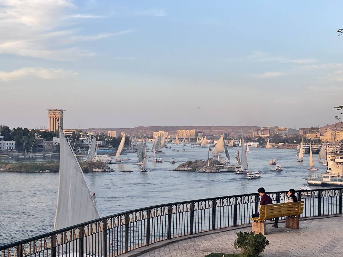 Traditional felucca sailboats on the Nile River at sunset in Aswan, Egypt