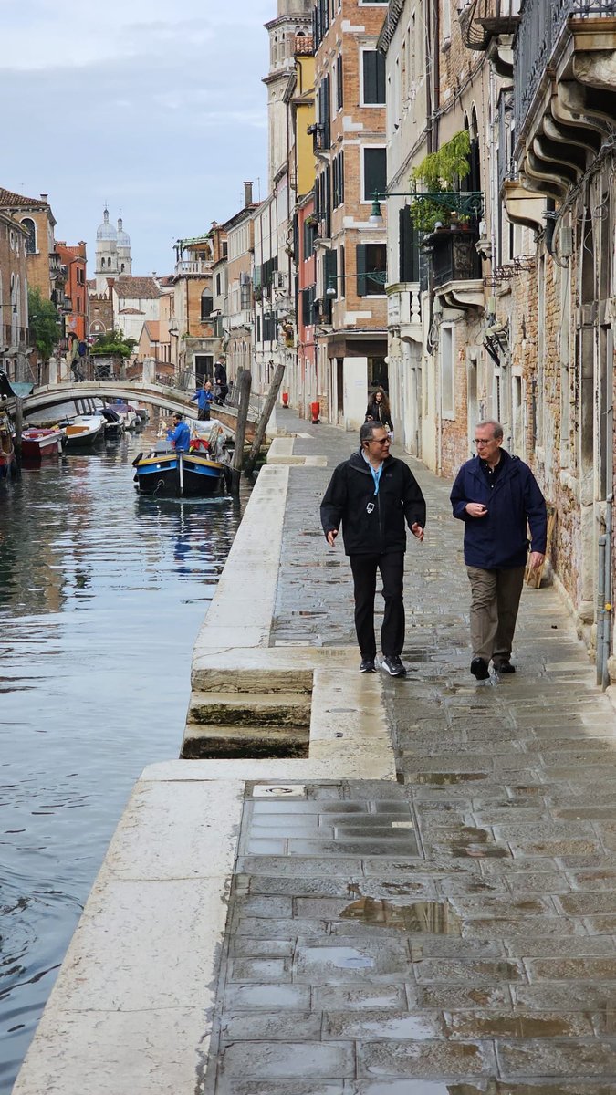 Dr. Thomas Madden walking along a Venice canal with a licensed Venetian guide